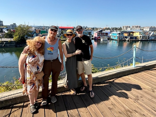 Pond surrounded by Willow tress and red flowers