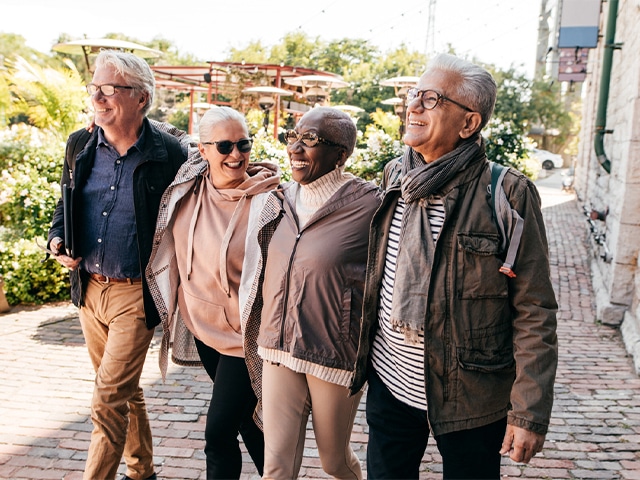 Two glasses of white wine on table with vineyard in background